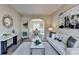 Stylish living room with modern decor, hardwood flooring, and an arched doorway to the dining area at 355 Holland Springs Way, Powder Springs, GA 30127