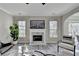 Living room features decorative fireplace, area rug, modern furniture and lots of light at 355 Holland Springs Way, Powder Springs, GA 30127