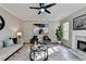 Living room features decorative fireplace, area rug, modern furniture and lots of light at 355 Holland Springs Way, Powder Springs, GA 30127