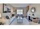 Well-lit living room with neutral walls, hardwood floors, and contemporary furnishings at 355 Holland Springs Way, Powder Springs, GA 30127