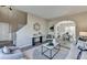 Bright living room featuring an open floor plan, hardwood flooring, and access to the dining area at 355 Holland Springs Way, Powder Springs, GA 30127