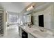 Luxurious primary bathroom featuring dual sinks, and a large framed mirror at 355 Holland Springs Way, Powder Springs, GA 30127