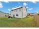 Backyard featuring a well-maintained lawn, patio with seating, and partial fencing at 8819 Sibella Ct, Lithia Springs, GA 30122