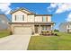 Two-story house with a neutral color scheme and a landscaped lawn at 8819 Sibella Ct, Lithia Springs, GA 30122