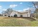 A view of the backyard with a grassy area and the home's exterior with an air conditioning unit at 50 Silver Tip Ct, Mcdonough, GA 30253