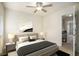 This bedroom is complete with ceiling fan, neutral walls, and plush bedding at 5104 Leeshire Se Trl # 64, Atlanta, GA 30339