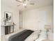 Bedroom with neutral walls and flooring features a ceiling fan and lamp at 5104 Leeshire Se Trl # 64, Atlanta, GA 30339