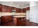 Gourmet kitchen features wood cabinets, granite counters, stainless appliances, and a large center island at 5104 Leeshire Se Trl # 64, Atlanta, GA 30339