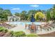 Resort-style community pool with lounge chairs, tables, umbrellas, and clubhouse at 5104 Leeshire Se Trl # 64, Atlanta, GA 30339