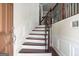 Elegant curved staircase with dark wood and wrought iron railing at 5104 Leeshire Se Trl # 64, Atlanta, GA 30339