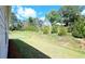 Landscaped backyard with grassy area and mature trees at 621 Pineberry Ct, Grayson, GA 30017