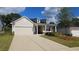 House exterior featuring a two-car garage, front porch, and landscaped lawn at 621 Pineberry Ct, Grayson, GA 30017