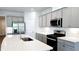 Modern kitchen island with sink, stainless steel appliances, and quartz countertops at 621 Pineberry Ct, Grayson, GA 30017