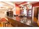 This bar features granite countertops, a mini-sink, wooden stools, and a CHEERS sign above the liquor cabinet at 4703 Legacy Cove Ln, Smyrna, GA 30126