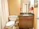 Bathroom with a dark granite countertop, a sink with chrome fixtures and a toilet with a shower curtain at 4703 Legacy Cove Ln, Smyrna, GA 30126