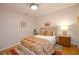 Cozy bedroom with hardwood floors, warm lighting, and floral bedding, creating a comfortable space at 4703 Legacy Cove Ln, Smyrna, GA 30126
