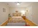 Cozy bedroom with hardwood floors, natural light, and a comfortable bed perfect for relaxation at 4703 Legacy Cove Ln, Smyrna, GA 30126