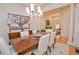 Dining room with elegant chandelier and large artwork, adjacent to living area at 4703 Legacy Cove Ln, Smyrna, GA 30126