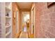 Inviting hallway features hardwood floors, brick walls, and built in shelving at 4703 Legacy Cove Ln, Smyrna, GA 30126