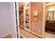 Hallway features brick walls, hardwood floors, a staircase, and opens to bathroom at 4703 Legacy Cove Ln, Smyrna, GA 30126