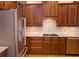 Kitchen features stainless steel refrigerator, wood cabinets and granite counters at 4703 Legacy Cove Ln, Smyrna, GA 30126