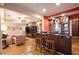 Open concept living room with a bar, hardwood floors, neutral paint, ceiling fan, and comfortable seating at 4703 Legacy Cove Ln, Smyrna, GA 30126