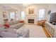 Bright living room with fireplace and large windows, seamlessly connected to dining area at 4703 Legacy Cove Ln, Smyrna, GA 30126