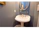 Stylish powder room featuring a pedestal sink and modern gray walls at 4703 Legacy Cove Ln, Smyrna, GA 30126