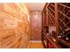Wine cellar with wine rack and walls made of wooden wine boxes and a red brick wall at 4703 Legacy Cove Ln, Smyrna, GA 30126
