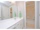 Bright bathroom featuring a large mirror, vanity, and a shower-tub combo at 4703 Legacy Cove Ln, Smyrna, GA 30126