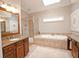 Spacious bathroom featuring a soaking tub, stand-up shower, and double sinks at 4703 Legacy Cove Ln, Smyrna, GA 30126