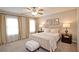 Bedroom with carpet, large bed, two windows, and lamps at 4703 Legacy Cove Ln, Smyrna, GA 30126