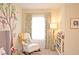 View of bedroom with decorated tree wall art, rocking chair and bookcase at 4703 Legacy Cove Ln, Smyrna, GA 30126