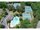 An aerial view showcasing the community's tennis courts, swimming pool, clubhouse, and well-maintained landscaping at 4703 Legacy Cove Ln, Smyrna, GA 30126