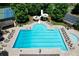A stunning aerial view of the community swimming pool with a waterslide and plenty of lounge chairs at 4703 Legacy Cove Ln, Smyrna, GA 30126