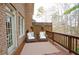 Cozy outdoor deck with comfortable seating, wood railings and brick structure at 4703 Legacy Cove Ln, Smyrna, GA 30126