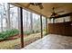 Covered patio with tile flooring, columns, ceiling fans and a view of a wooded backyard at 4703 Legacy Cove Ln, Smyrna, GA 30126