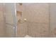 Walk-in shower with neutral-toned ceramic tiles, shower head and shelves at 4703 Legacy Cove Ln, Smyrna, GA 30126