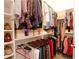 Organized walk-in closet with hanging clothes, shoe racks and pull-out shelves at 4703 Legacy Cove Ln, Smyrna, GA 30126