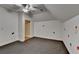 Spacious bonus room featuring a ceiling fan and dark grey carpeting at 5547 Nelson Pointe Dr, Stone Mountain, GA 30087