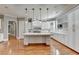 Modern kitchen with white cabinets, marble counters, and island at 5547 Nelson Pointe Dr, Stone Mountain, GA 30087