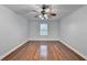 Bright bedroom featuring hardwood floors and a ceiling fan at 3473 Blanding Ct, Buford, GA 30519