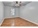 Well-lit bedroom with hardwood floors and a ceiling fan at 3473 Blanding Ct, Buford, GA 30519