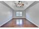 Bright bedroom with hardwood floors and a large window at 3473 Blanding Ct, Buford, GA 30519