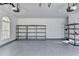 Garage with epoxy flooring and ample storage shelving at 3473 Blanding Ct, Buford, GA 30519