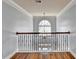 Open landing with hardwood floors and wrought iron railing at 3473 Blanding Ct, Buford, GA 30519