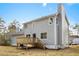 Rear view of the house with a deck, siding, chimney, and an air conditioning unit at 4390 Allgood Pl, Stone Mountain, GA 30083