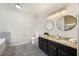 Bathroom with granite countertop, dual mirrors and modern bath fixtures at 4390 Allgood Pl, Stone Mountain, GA 30083