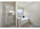 Bathroom featuring a glass enclosed shower and separate soaking tub at 4390 Allgood Pl, Stone Mountain, GA 30083