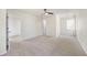 Spacious bedroom with neutral carpet, ceiling fan and multiple windows at 4390 Allgood Pl, Stone Mountain, GA 30083